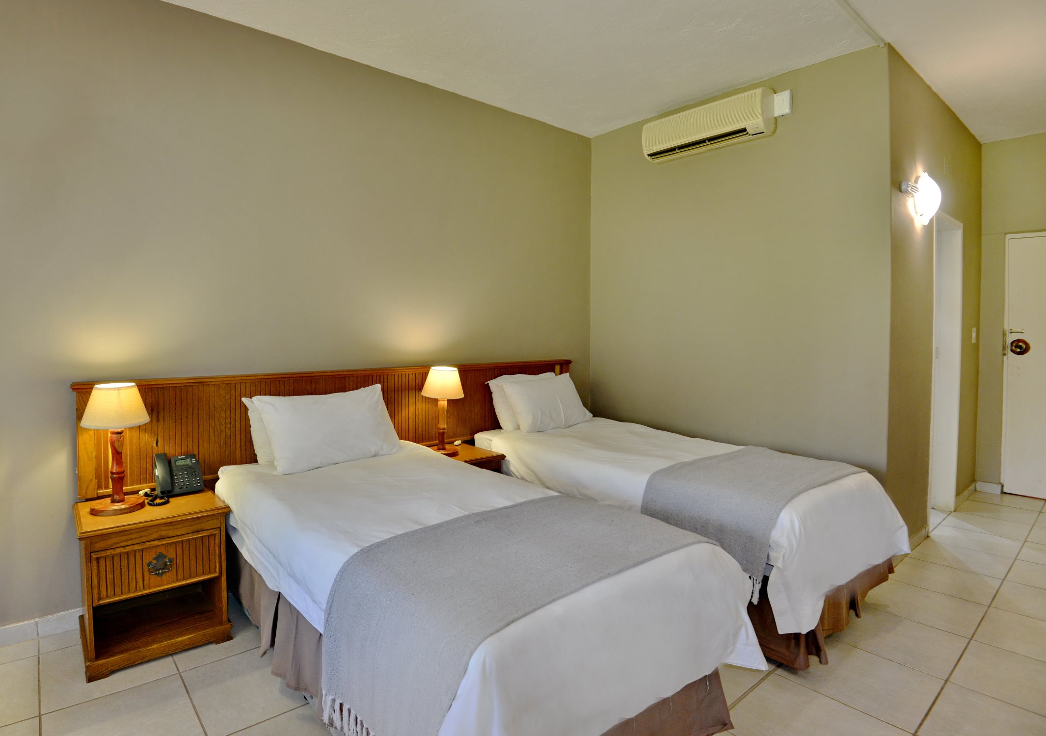 Hotel room with separate beds near Sun City and Pilanesberg
