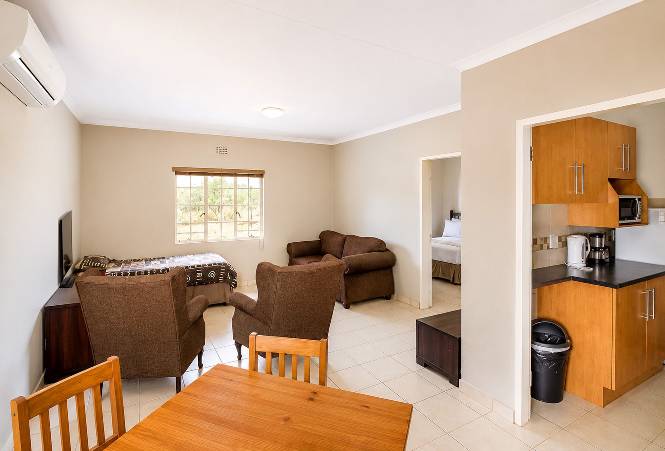 Standard One-Bedroom Chalet lounge and kitchen area near Sun City