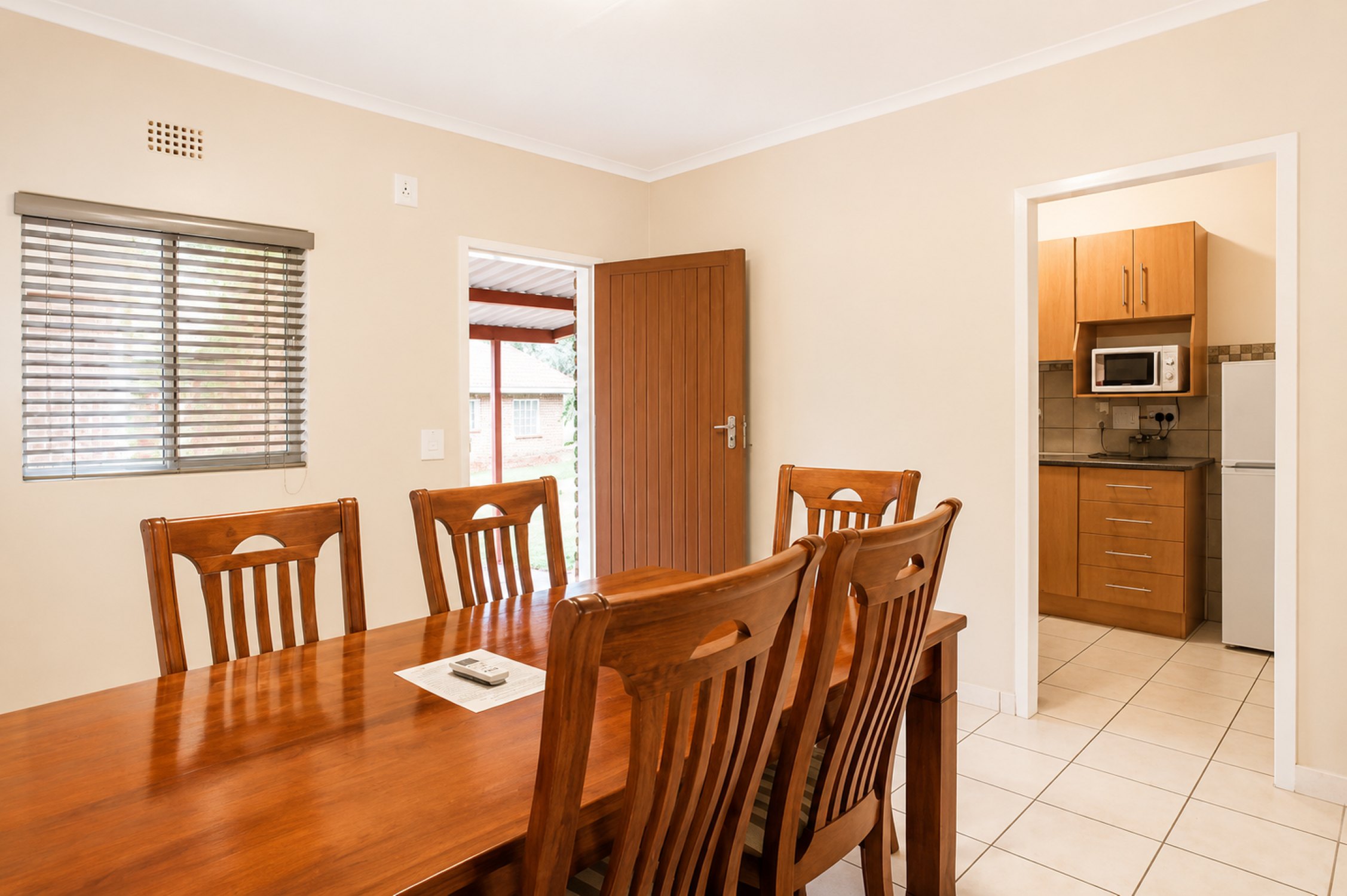 Dining area and kitchen in the Standard Two-Bedroom Self-Catering Chalet near Sun City